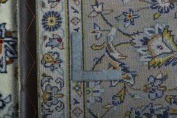 Backside of handmade 2000s Kashan rug showing knot structure and weave density