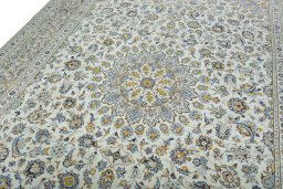 Backside of handmade 2000s Kashan rug showing knot structure and weave density