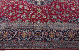 Corner detail of 2000s Kashan rug showing border pattern and Wool pile