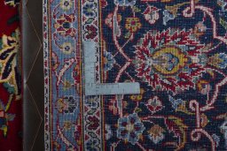 Backside of handmade 2000s Kashan rug showing knot structure and weave density