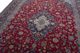 Backside of handmade 2000s Kashan rug showing knot structure and weave density