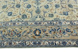Corner detail of 2000s Kashan rug showing border pattern and Wool pile