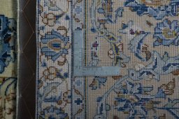 Backside of handmade 2000s Kashan rug showing knot structure and weave density