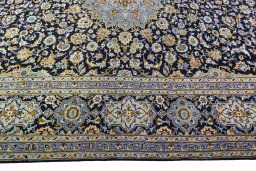 Corner detail of 2000s Kashan rug showing border pattern and Wool pile