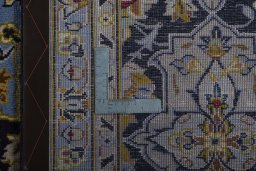 Backside of handmade 2000s Kashan rug showing knot structure and weave density
