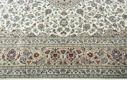 Corner detail of 2000s Kashan rug showing border pattern and Wool pile