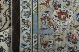 Backside of handmade 2000s Kashan rug showing knot structure and weave density
