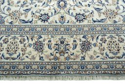 Corner detail of 2000s Kashan rug showing border pattern and Wool pile