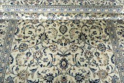 Backside of handmade 2000s Kashan rug showing knot structure and weave density
