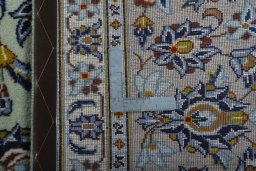 Backside of handmade 2000s Kashan rug showing knot structure and weave density