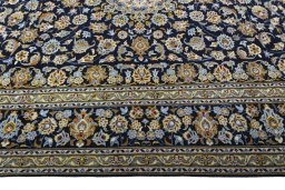 Corner detail of 2000s Kashan rug showing border pattern and Wool pile
