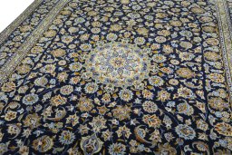 Backside of handmade 2000s Kashan rug showing knot structure and weave density