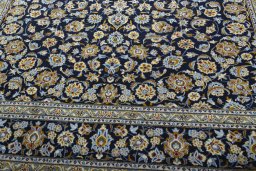 Close-up detail of 2000s Kashan rug from Iran / Persia showing Wool weave