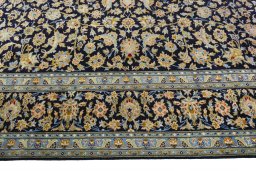 Corner detail of 2000s Kashan rug showing border pattern and Wool pile