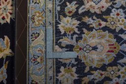 Backside of handmade 2000s Kashan rug showing knot structure and weave density