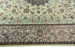 Corner detail of 2000s Kashan rug showing border pattern and Wool pile