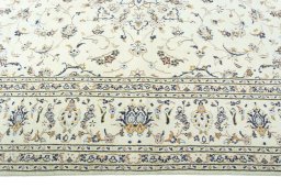 Corner detail of 2000s Kashan rug showing border pattern and Wool pile