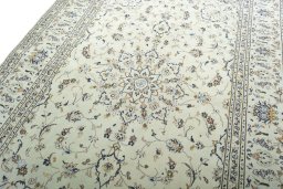 Backside of handmade 2000s Kashan rug showing knot structure and weave density