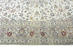 Corner detail of 2000s Kashan rug showing border pattern and Wool pile
