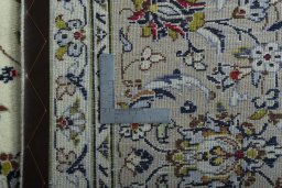 Backside of handmade 2000s Kashan rug showing knot structure and weave density