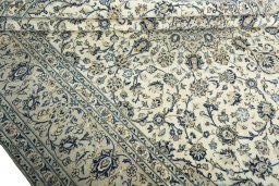 Corner detail of 2000s Kashan rug showing border pattern and Wool pile