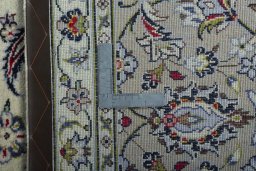 Backside of handmade 2000s Kashan rug showing knot structure and weave density