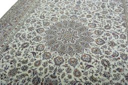 Backside of handmade 2000s Kashan rug showing knot structure and weave density