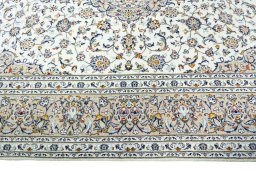 Corner detail of 2000s Kashan rug showing border pattern and Wool pile