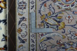 Backside of handmade 2000s Kashan rug showing knot structure and weave density