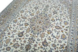 Backside of handmade 2000s Kashan rug showing knot structure and weave density
