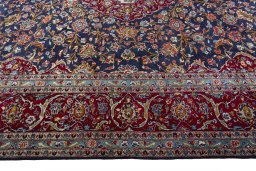 Corner detail of 2000s Kashan rug showing border pattern and Wool pile