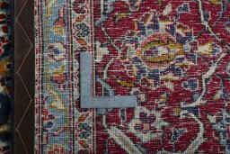 Backside of handmade 2000s Kashan rug showing knot structure and weave density