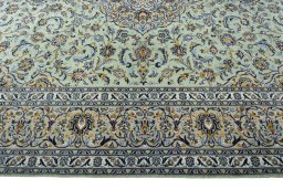 Corner detail of 2000s Kashan rug showing border pattern and Wool pile