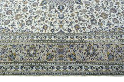 Corner detail of 2000s Kashan rug showing border pattern and Wool pile