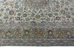 Corner detail of 2000s Kashan rug showing border pattern and Wool pile
