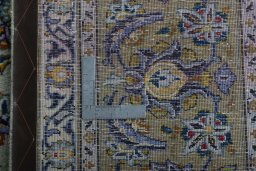 Backside of handmade 2000s Kashan rug showing knot structure and weave density