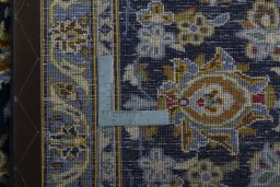 Backside of handmade 2000s Kashan rug showing knot structure and weave density