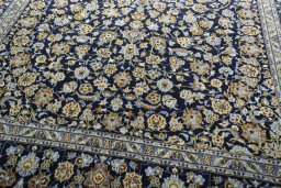Close-up detail of 2000s Kashan rug from Iran / Persia showing Wool weave