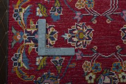 Backside of handmade 2000s Kashan rug showing knot structure and weave density