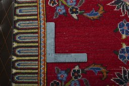 Backside of handmade New Kashan rug showing knot structure and weave density