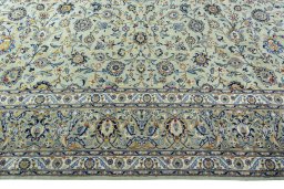 Corner detail of 2000s Kashan rug showing border pattern and Wool pile