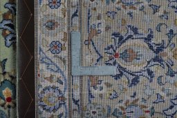 Backside of handmade 2000s Kashan rug showing knot structure and weave density