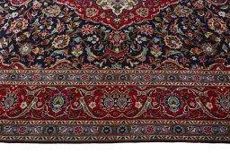 Corner detail of 2000s Kashan rug showing border pattern and Wool pile
