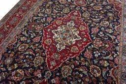 Backside of handmade 2000s Kashan rug showing knot structure and weave density