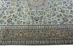 Corner detail of 2000s Kashan rug showing border pattern and Wool pile