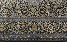 Corner detail of 2000s Kashan rug showing border pattern and Wool pile
