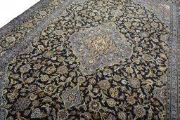 Backside of handmade 2000s Kashan rug showing knot structure and weave density