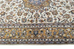 Corner detail of 2000s Kashan rug showing border pattern and Wool pile