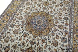 Backside of handmade 2000s Kashan rug showing knot structure and weave density