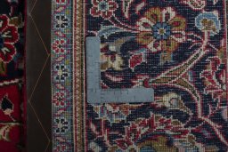 Backside of handmade 2000s Kashan rug showing knot structure and weave density